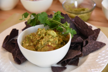 Ancho chile guacamole in a ceramic bowl with tortilla chips