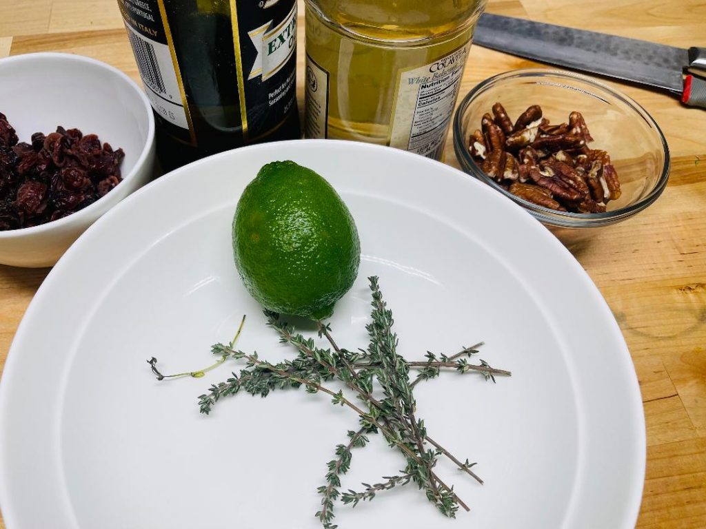 measuring white balsamic vinegar for thyme vinaigrette