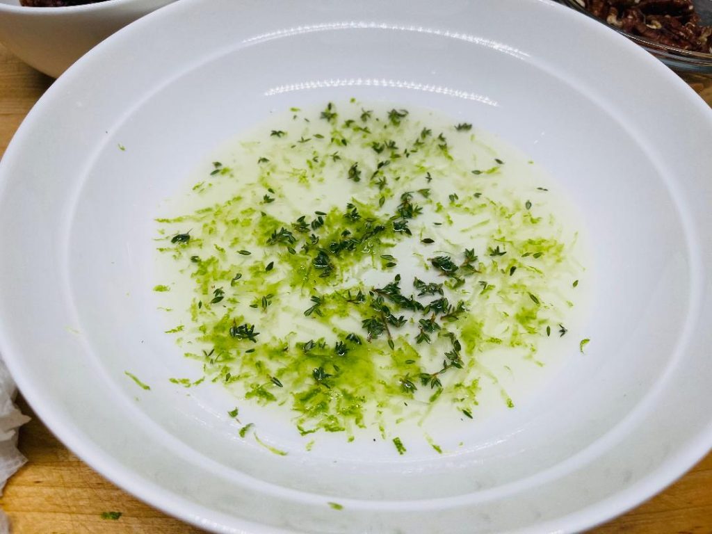 squeezing fresh lime juice into vinaigrette mixture