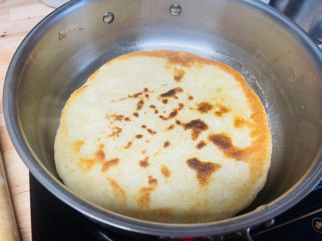 Homemade Pita Bread Recipe: Soft, Fresh & Ready in 90 Minutes 14 freshly cooked homemade pita bread stacked on board
