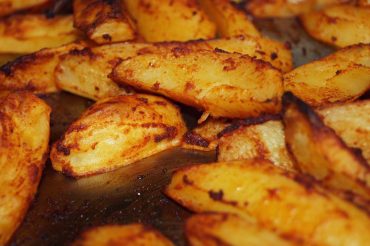 Greek lemon roasted potatoes (patates lemonates) in a baking dish
