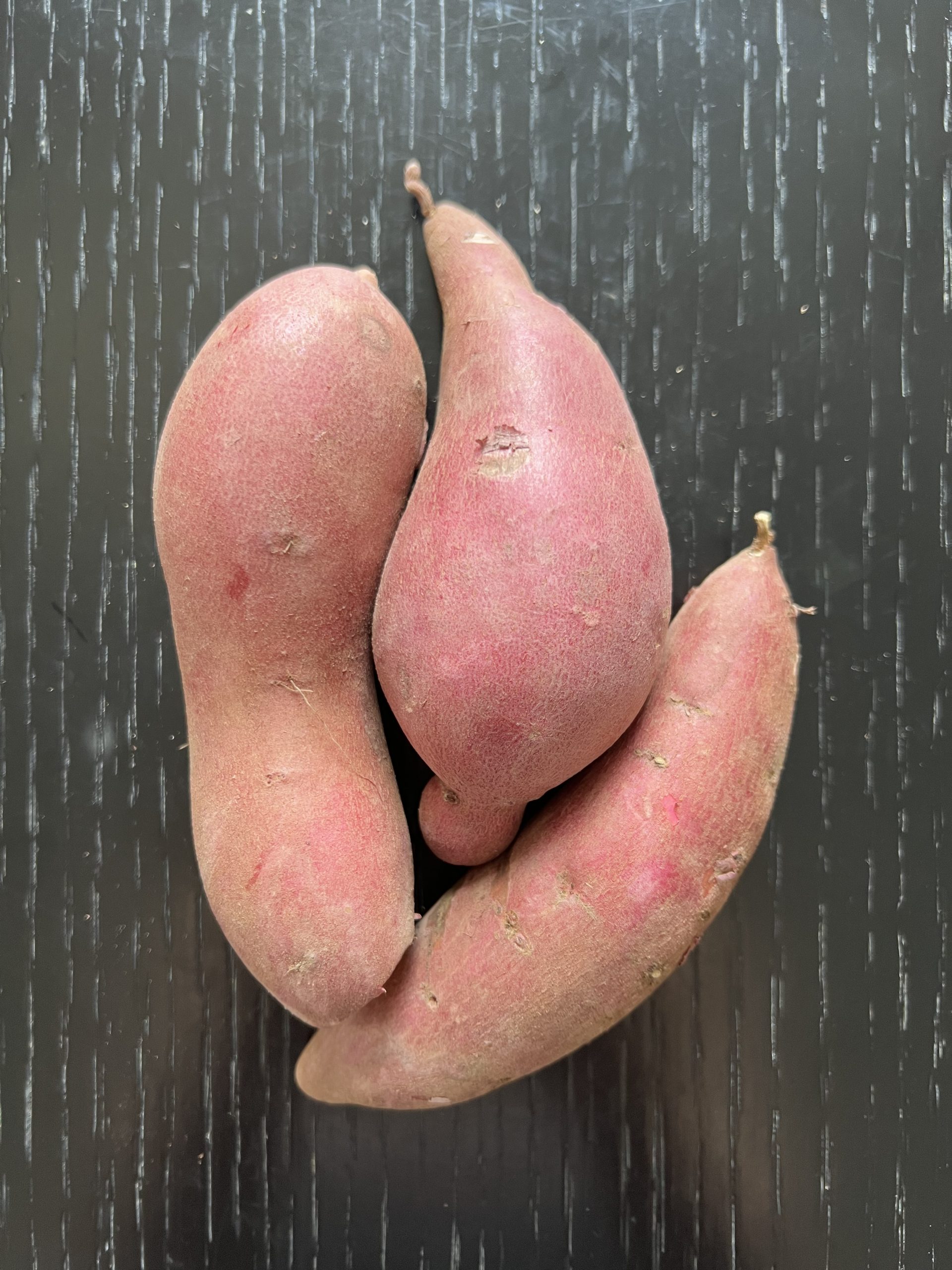 Fresh raw sweet potatoes with natural skin texture